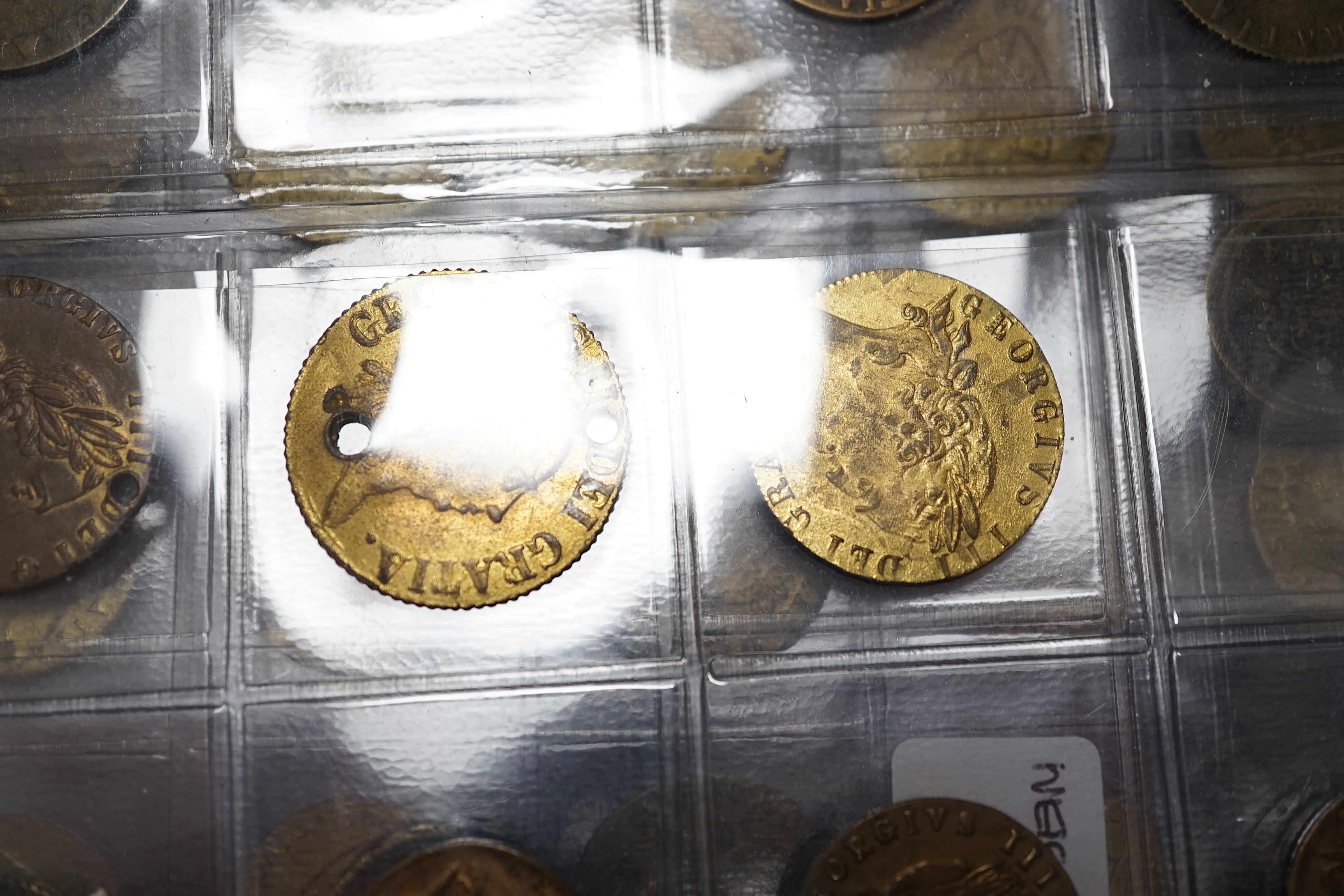 A large collection of halfpenny tokens and gaming tokens, 17th to early 20th century, in an album